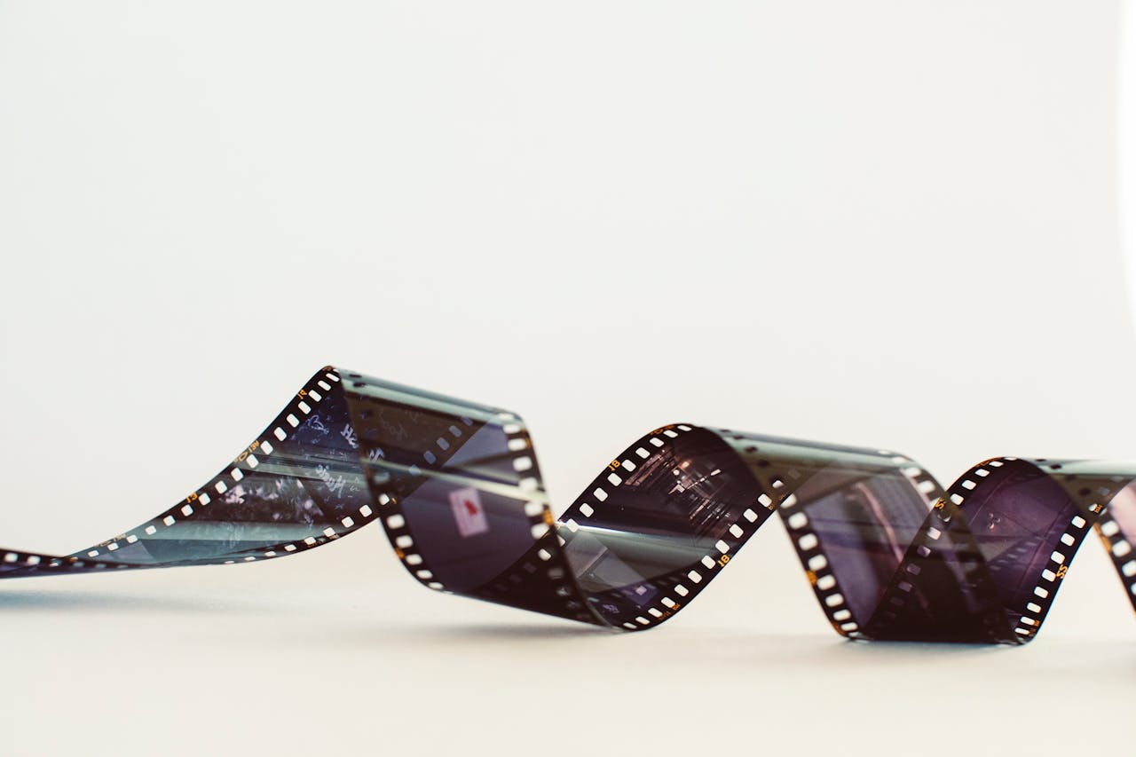 Close-up of a classic photographic film strip with a vintage feel against a white background.