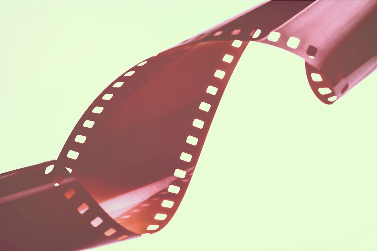 Curved vintage film strip on pastel background. Perfect for retro-themed designs.